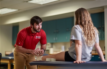 Athletic Training student taping an ankle