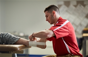 Student taping an ankle