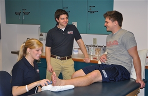 Athletic training student performing ultrasound treatment on a patient
