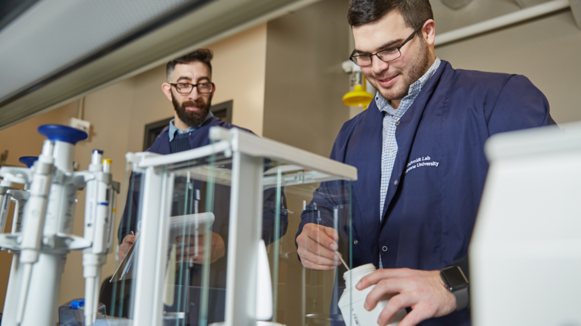 Two students working in engineering lab. 