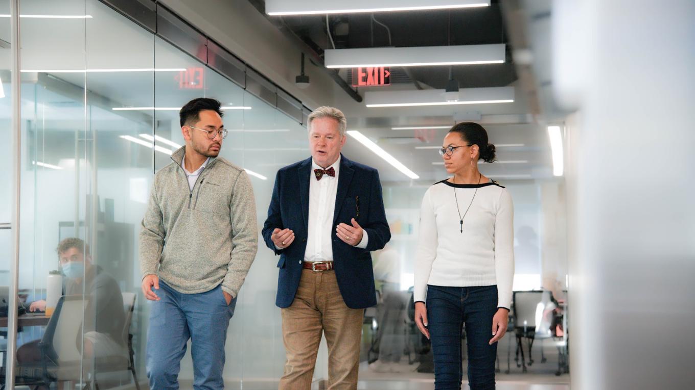 Professor and students walking