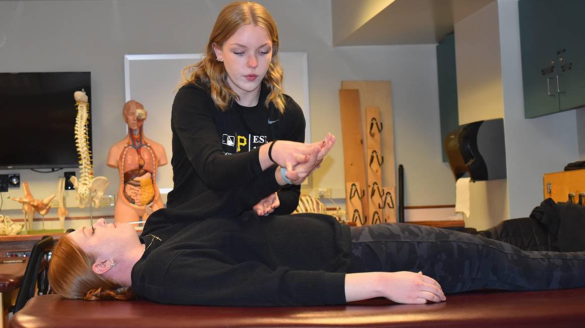 Student performing exercises with a patient