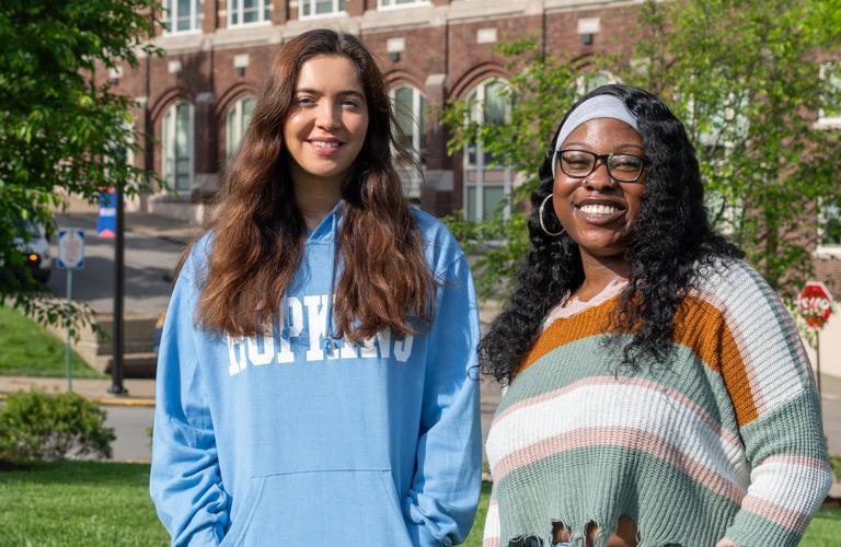 Public Health Grads standing in front of Rangos School of Health Sciences