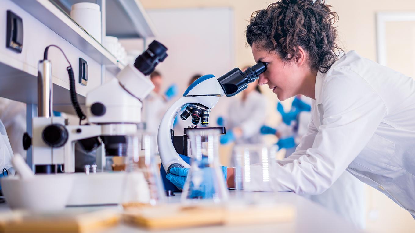 Student with a microscope.