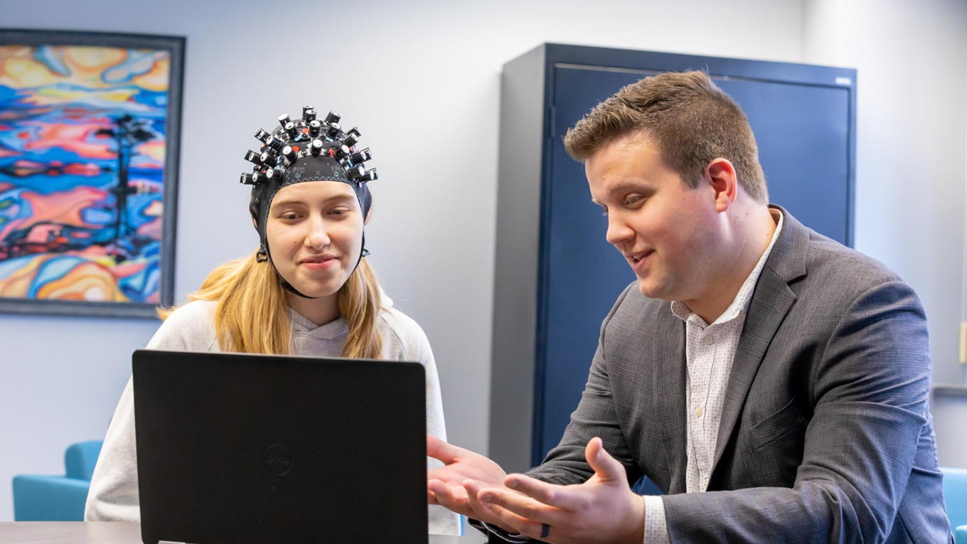 Dr. Tichenor and student at computer.