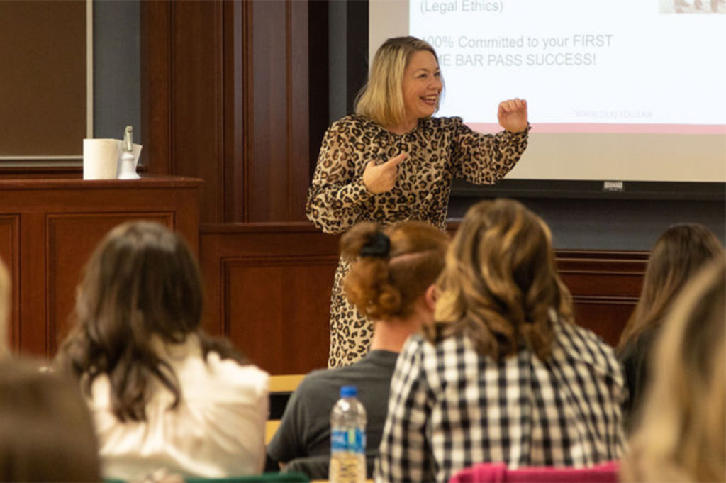 Female law professor enthusiastically presenting to class