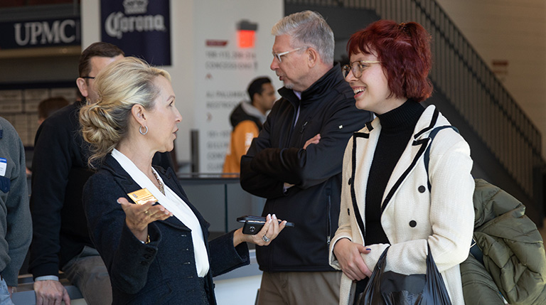 Dean Barton laughing and talking with law student