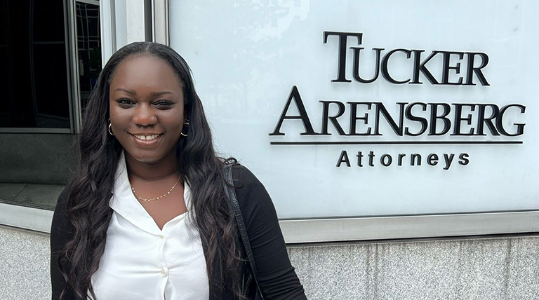 Tiffeny M. Ayoola headshot in front of Tucker Arensberg, P.C. law office