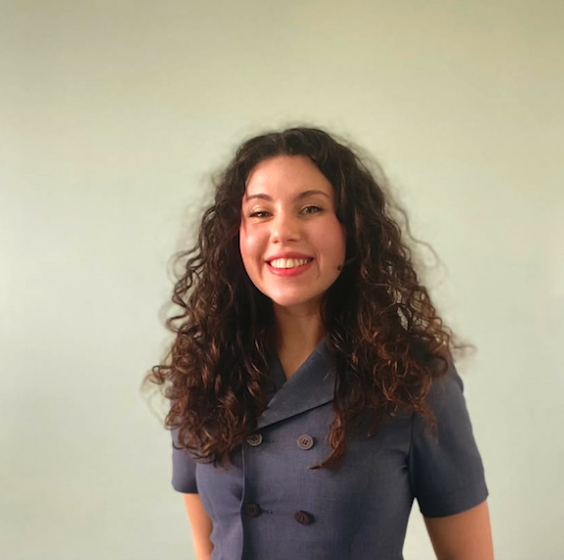 Extern Emily Tyler smiling in purple suit