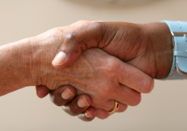 Picture of two people shaking hands.