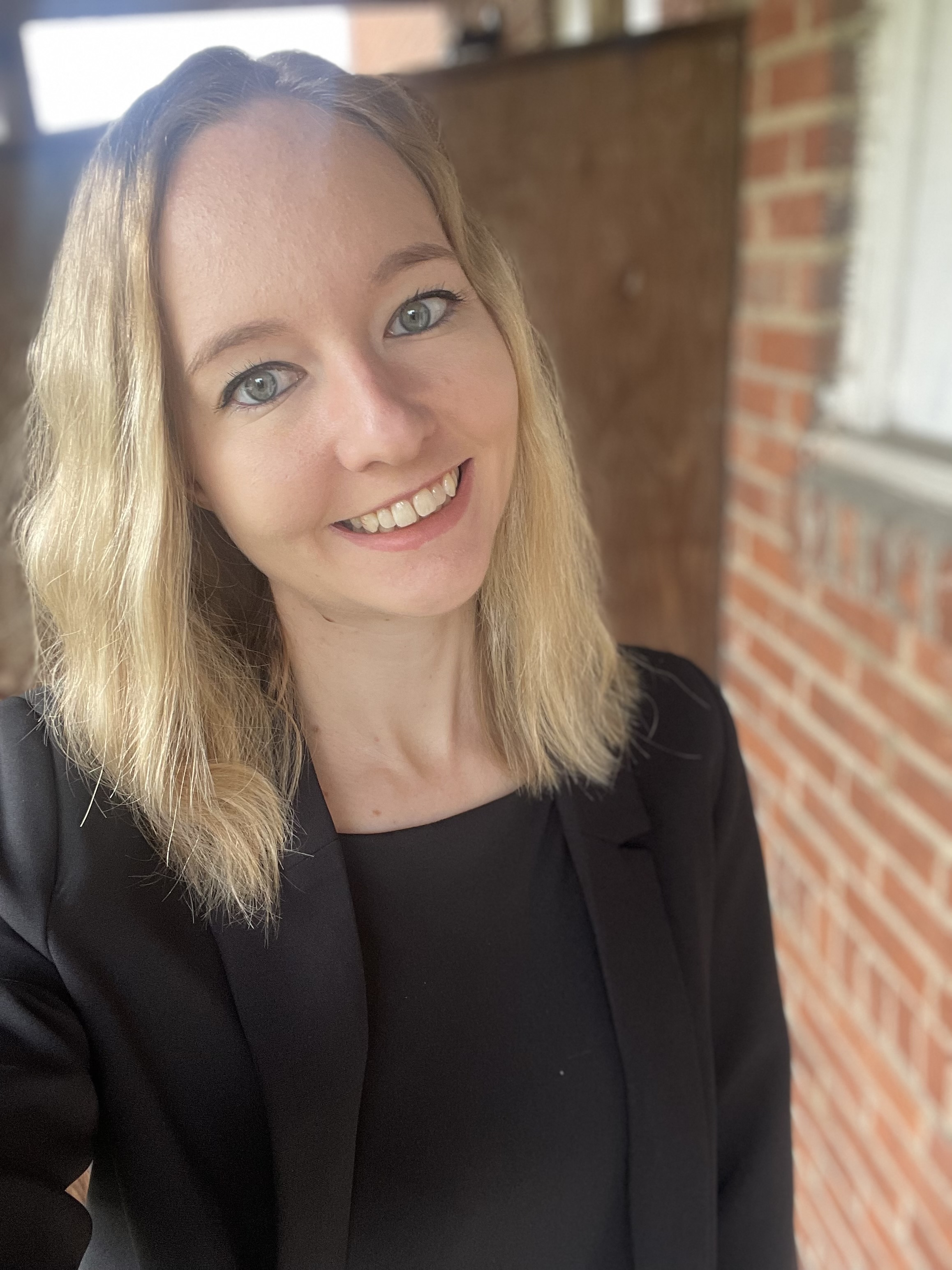 Extern Hayley Smith smiling in the law school hallway