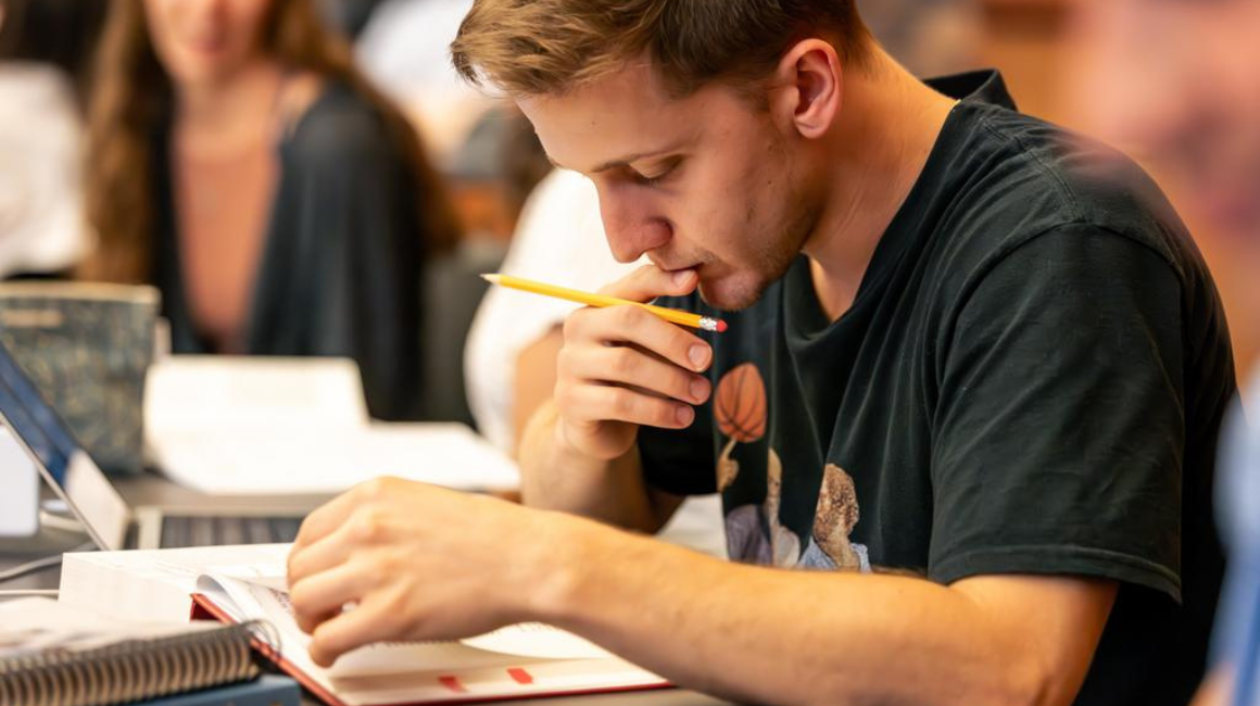 Male student in class reading