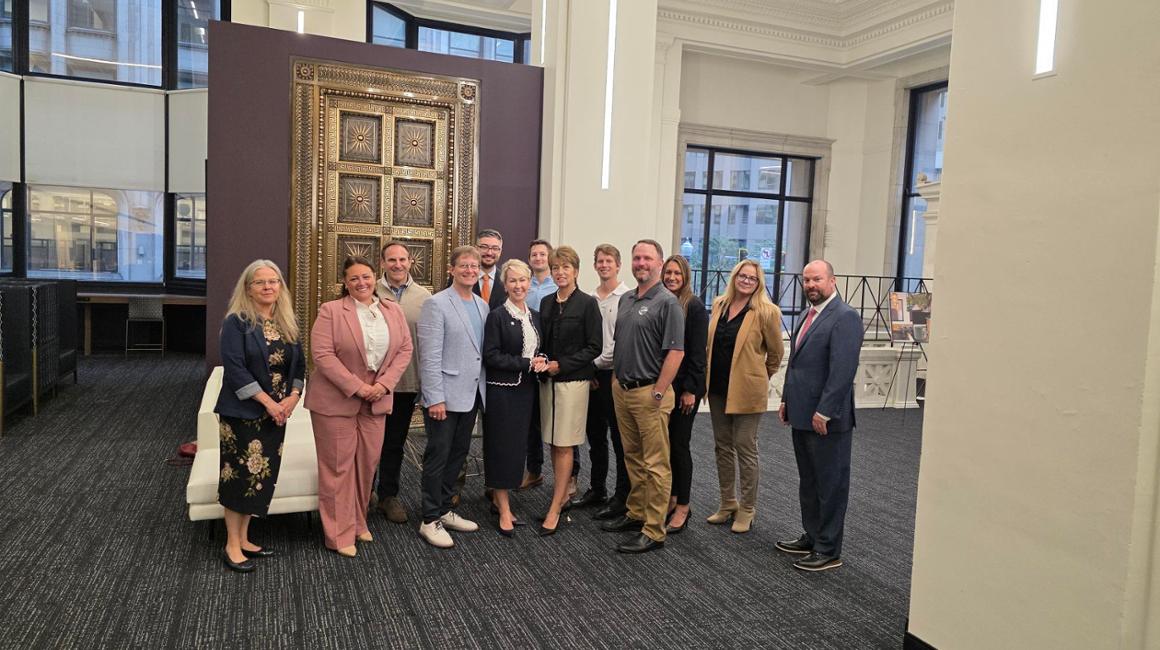 Group of people standing and smiling