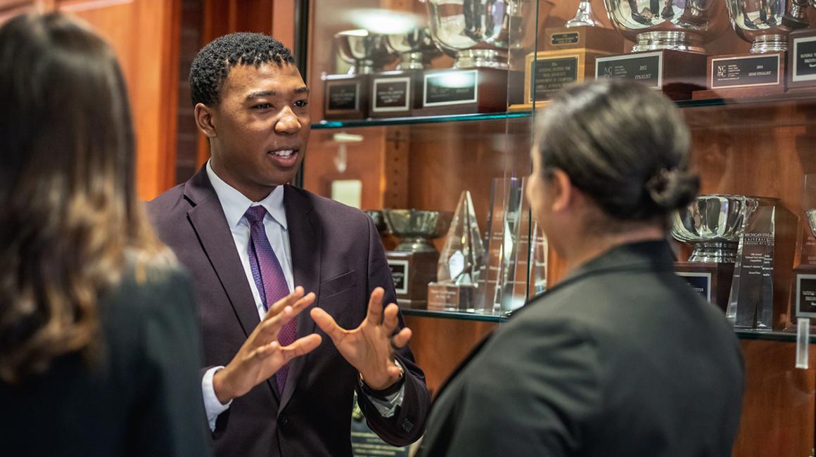 Law students talking with each other inside of the Thomas R. Kline School of Law of Duquesne University