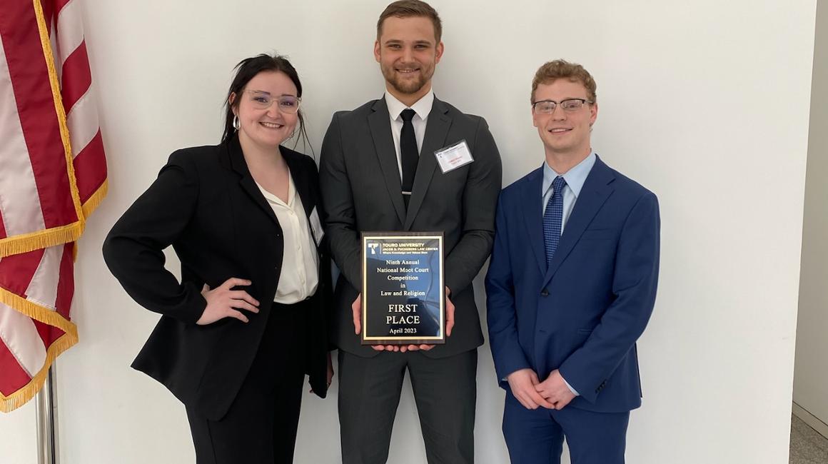 Three students with award