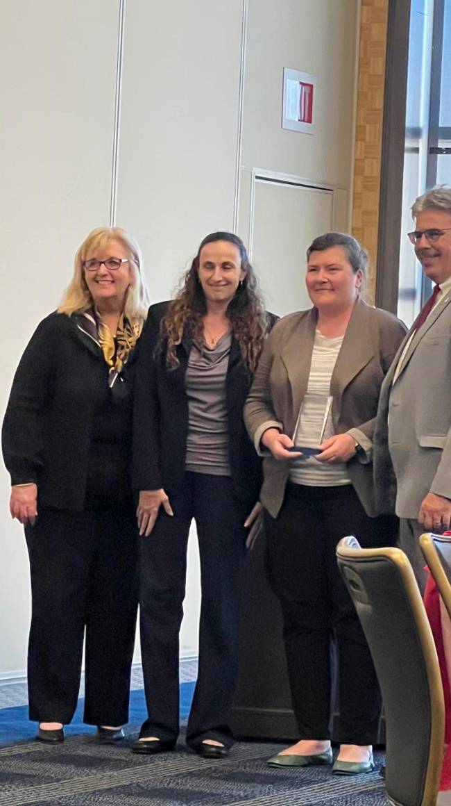 Four people with awards