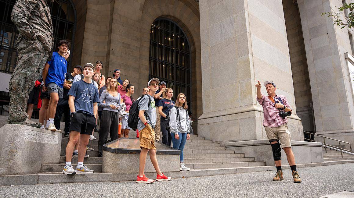 Dr. Greg Barnhisel guides students through a tour of Downtown, Pittsburgh.