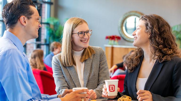 Two students talking with a Duquesne University employee in the Power Center