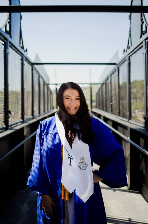 Photo of Alivia Montgomery in graduation gown on the bluff