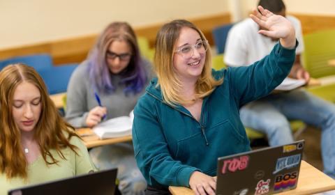 Kristen DeFlorio raises her hand in College Hall classroom.