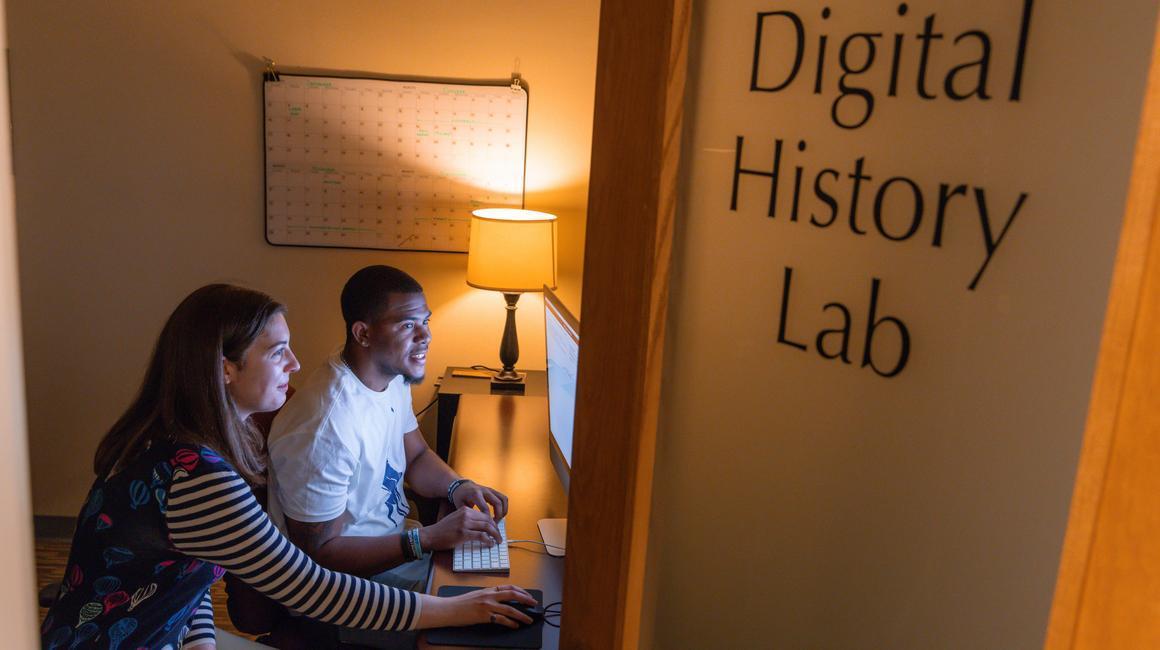 Two students working on a computer in the Digital History Lab.