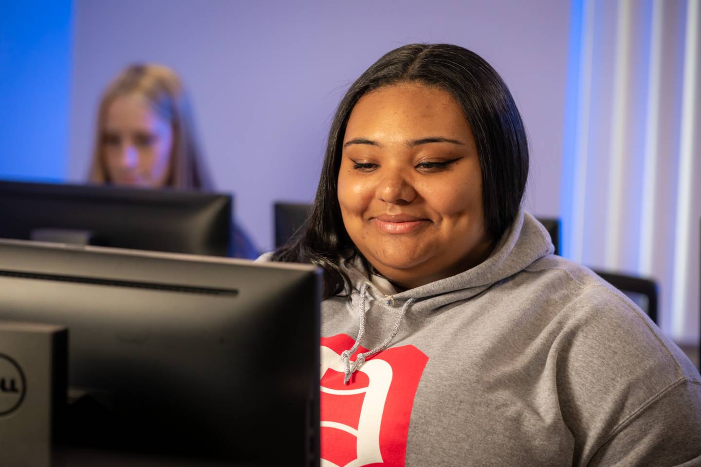 Student sitting behind a computer in a lab