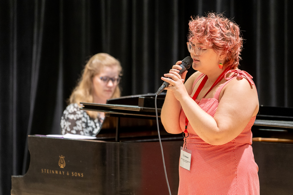 A singer performs with a pianist.