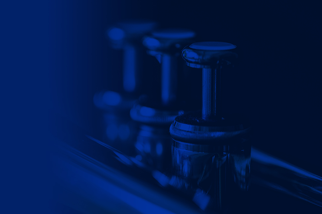 Blue image of trumpet valves.