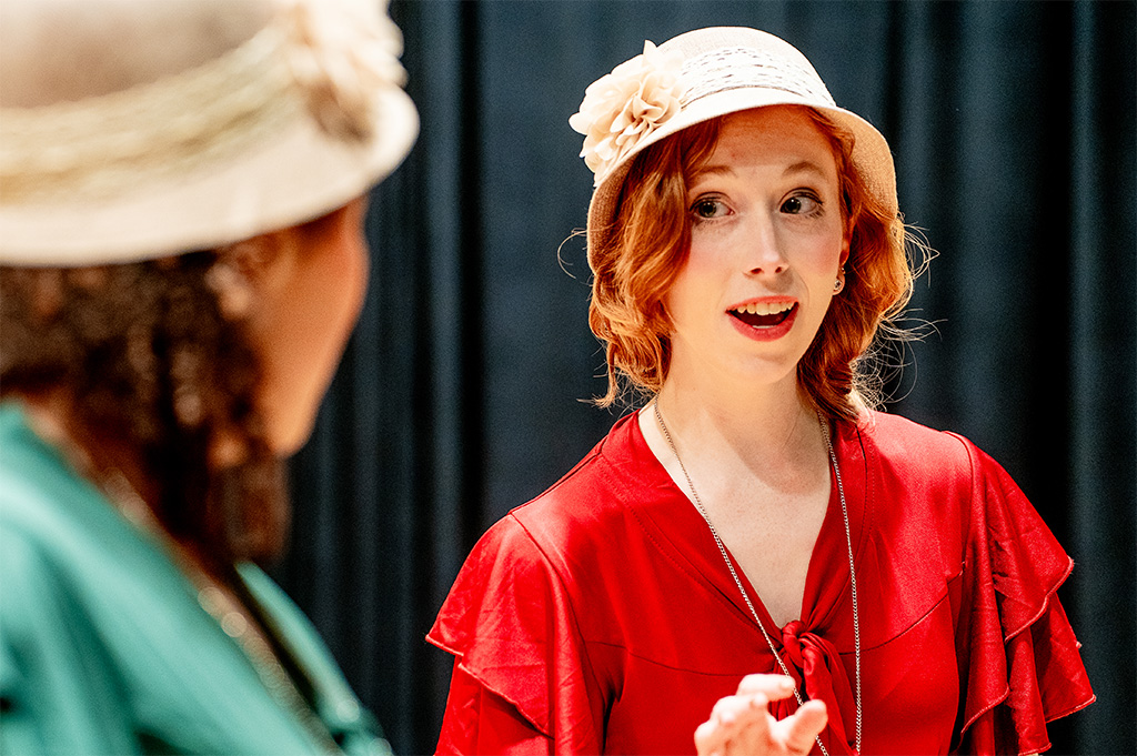 A person wearing a hat sings.