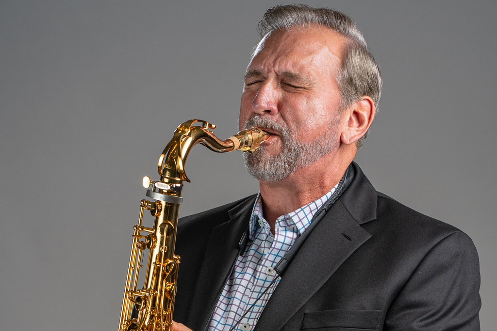 Mike Tomaro plays saxophone.