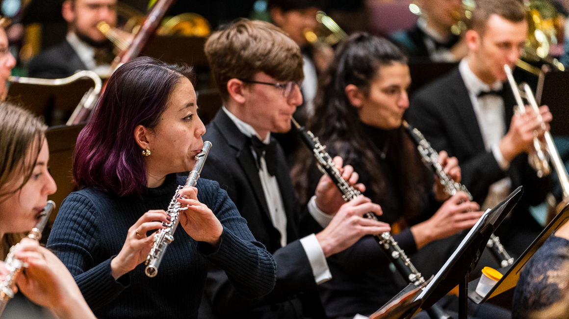 Flutists perform in concert.