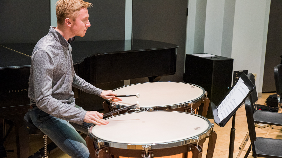 Student plays timpani.