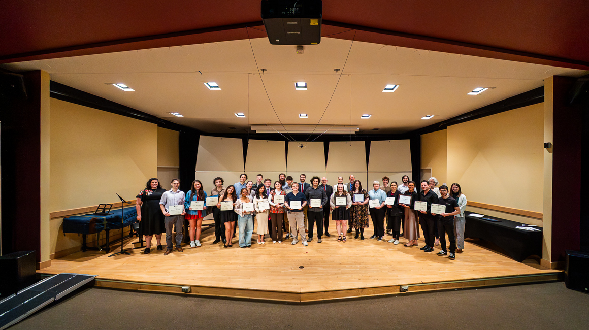 A group of award winners and presenters pose for a photo at the 2026 Awards Ceremony.