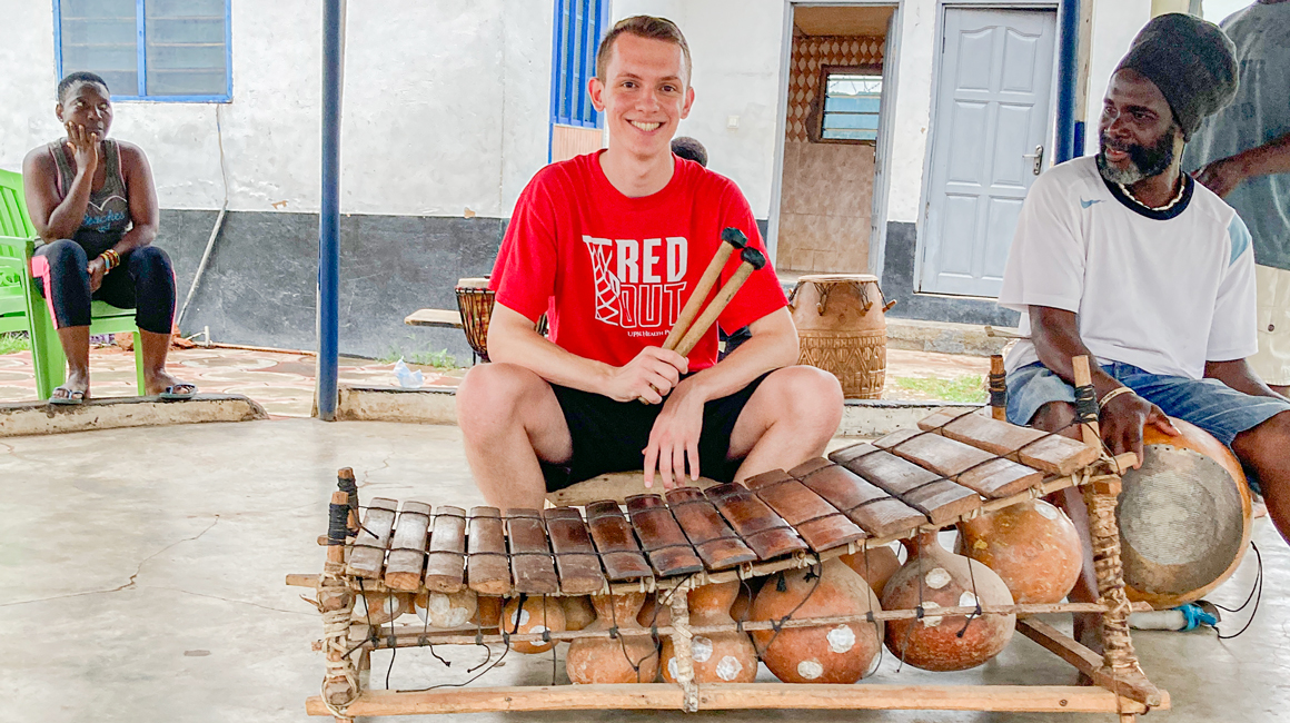 Student poses with a percussion instrument.