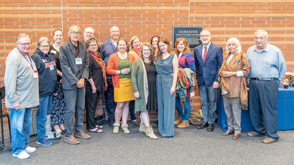 A group of alumni pose for a photo at an event.