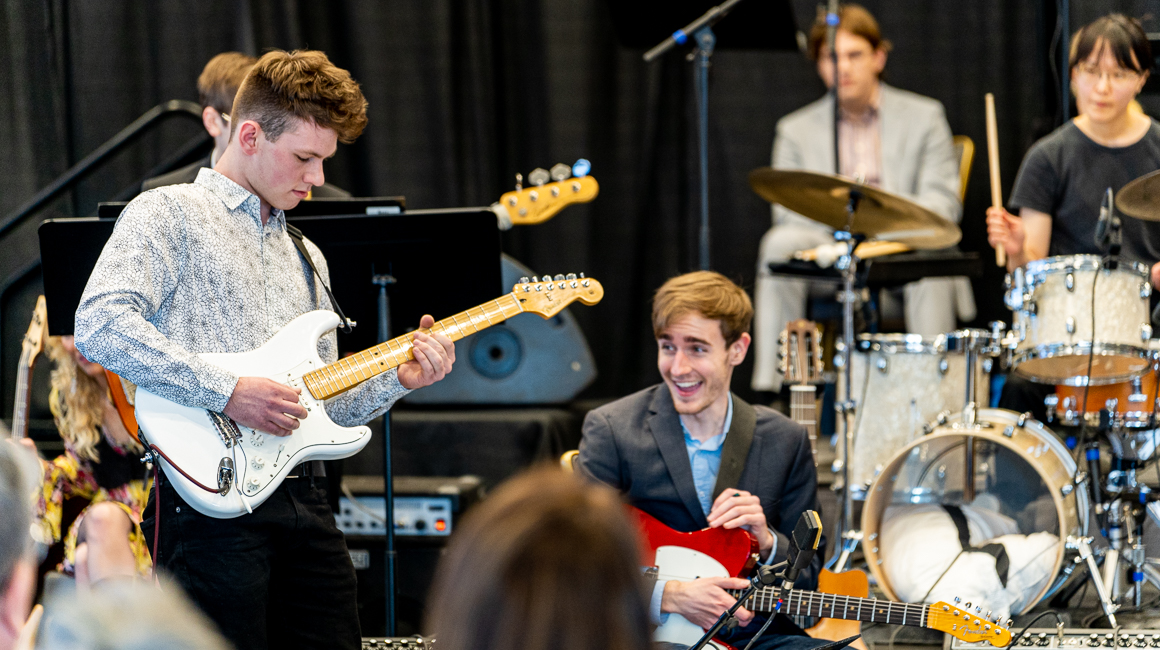 A guitartist plays with a jazz ensemble.