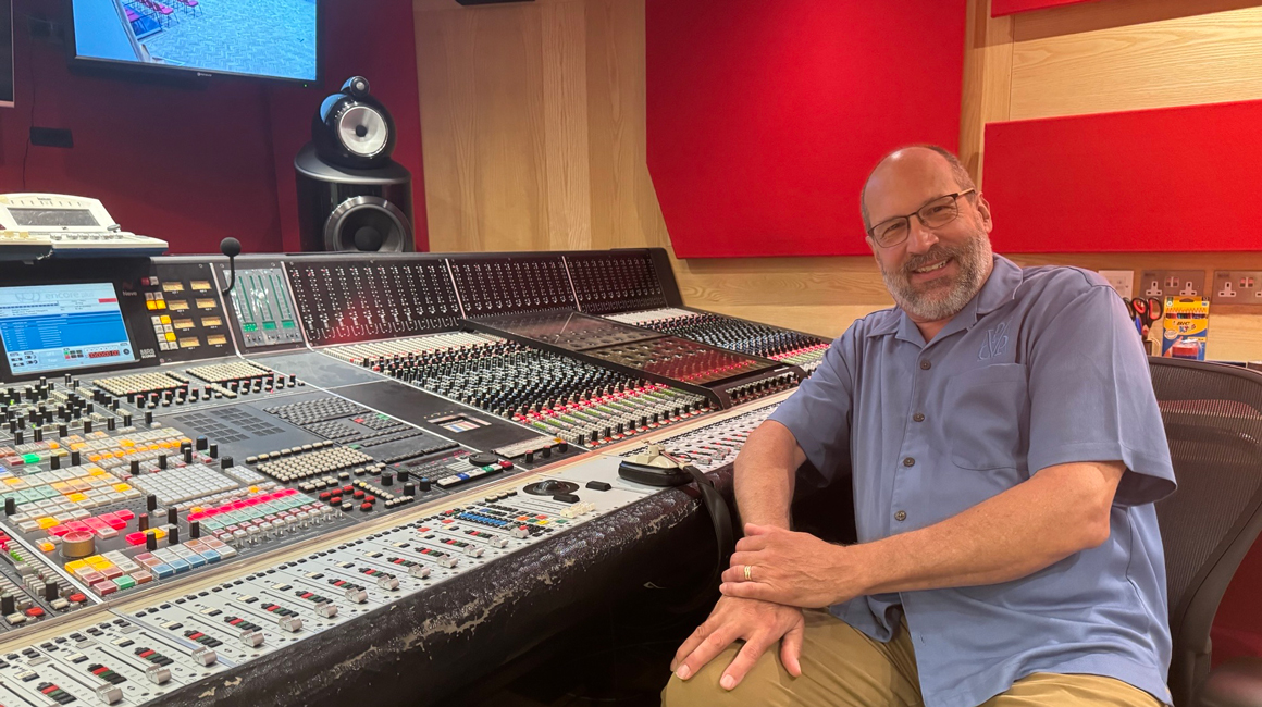 Person sits at a recording console in Abbey Road Studios in London.