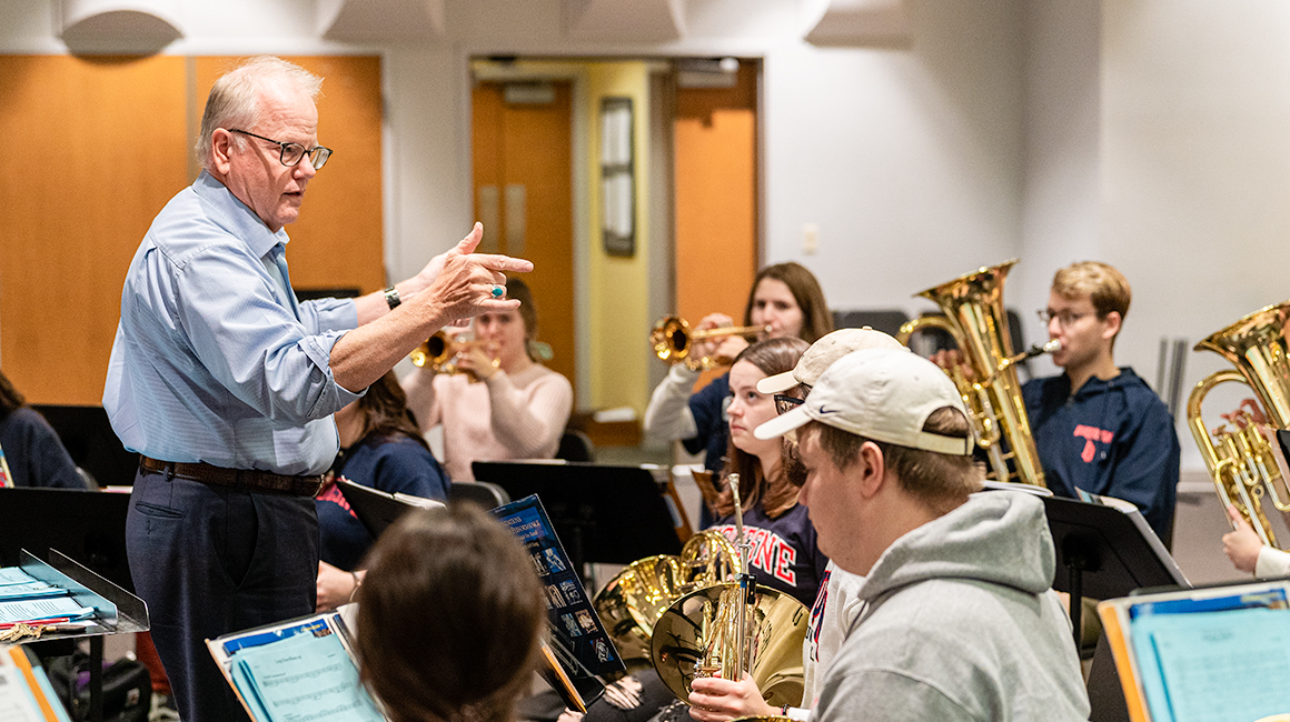 Professor teaches a brass class to music education majors
