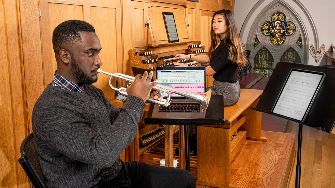 Students play trumpet and organ.