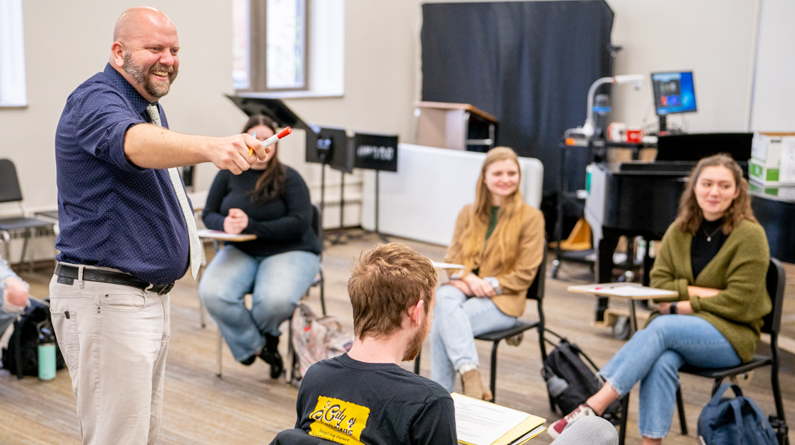 A professor engages with his classroom of students.