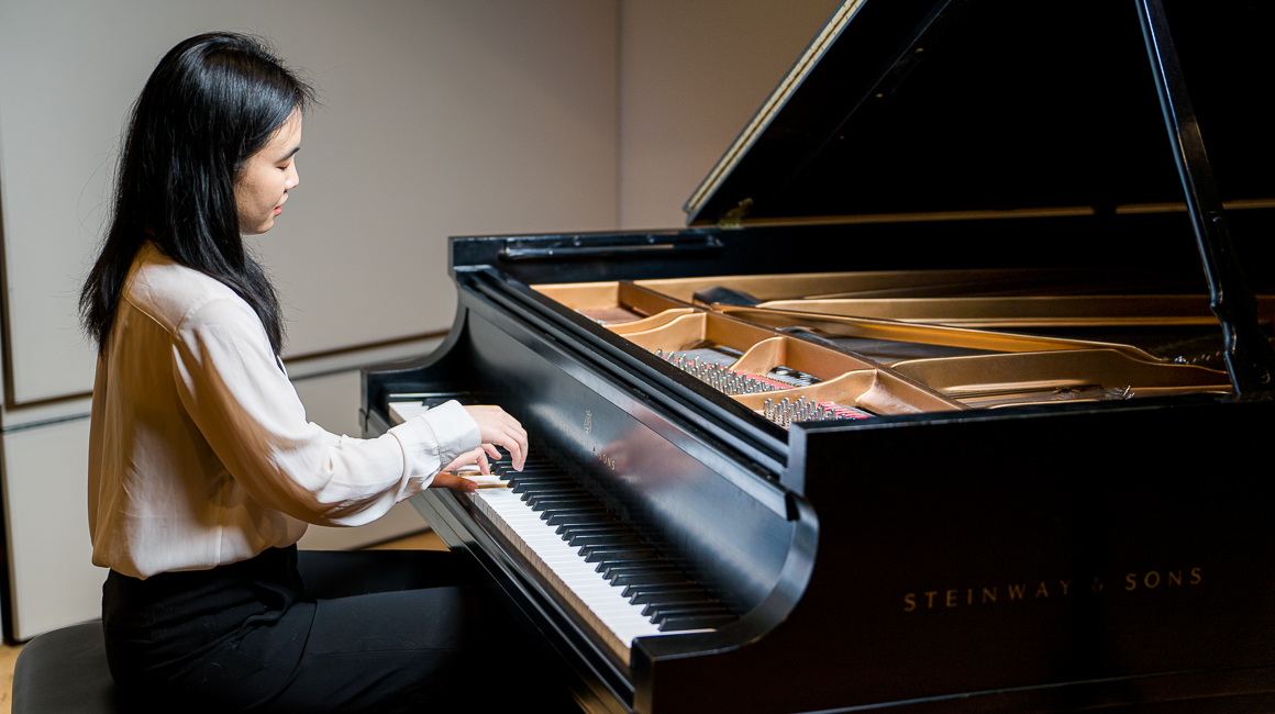 A pianist performs on a Steinway grand piano.