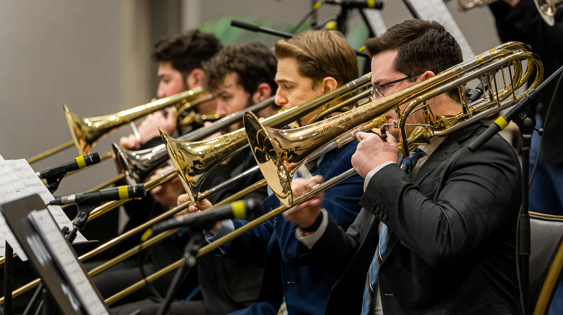 Four trombonists perform.