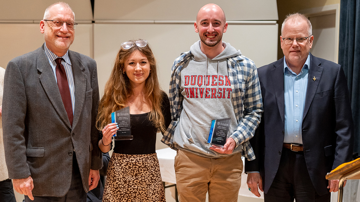 Students pose with their awards, alongside Dean and Department Chair for a photo.