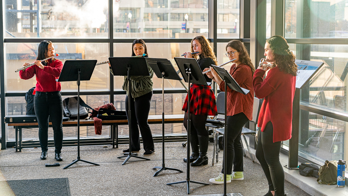 Five flute players perform.