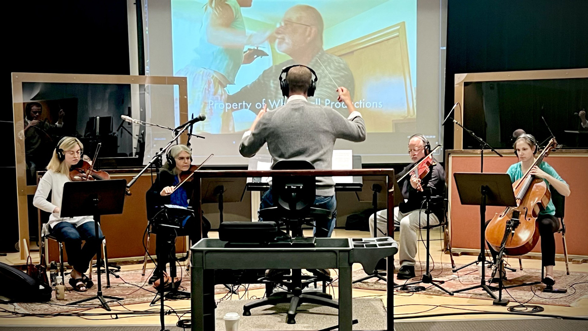 A string quartet playing in a recording studio.