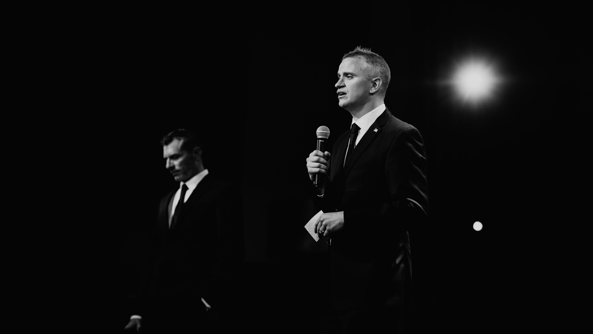 Black and white photo of two people in suits.