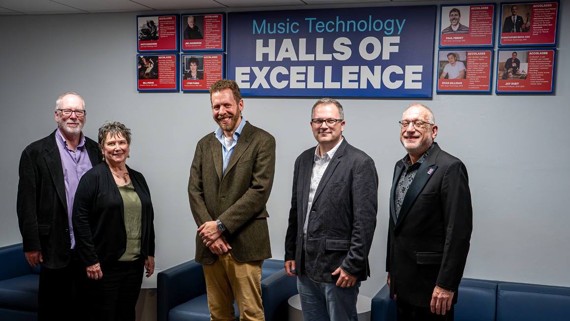 Five people stand under a sign reading Music Technology Halls of Excellence and eight individual accolades panels.