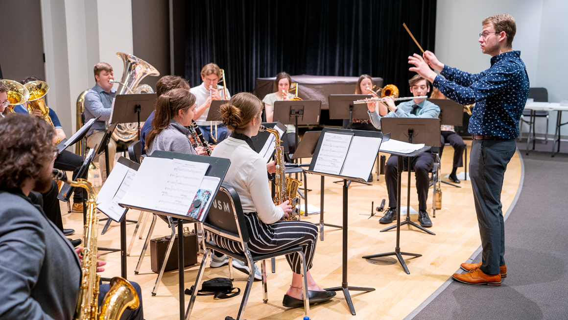 A student conducts an ensemble.