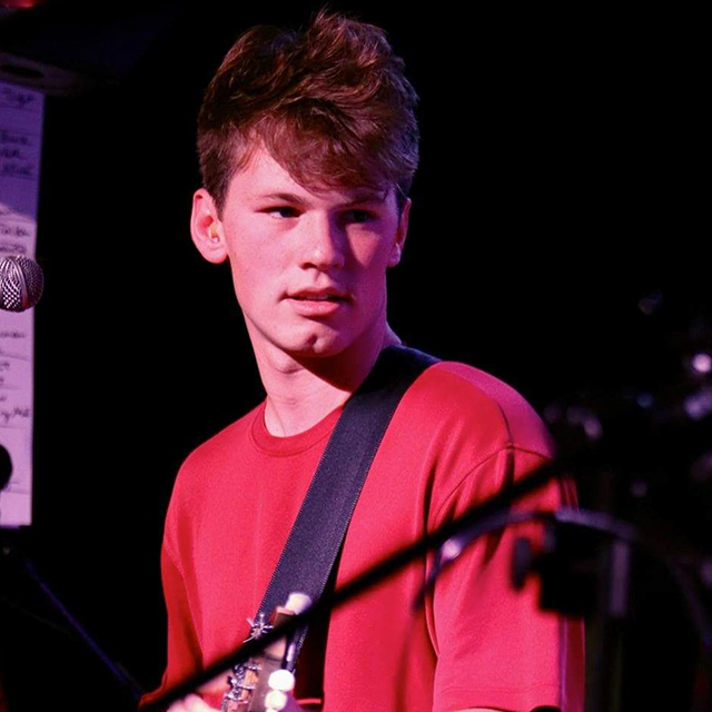 Jacob Zang plays a guitar.