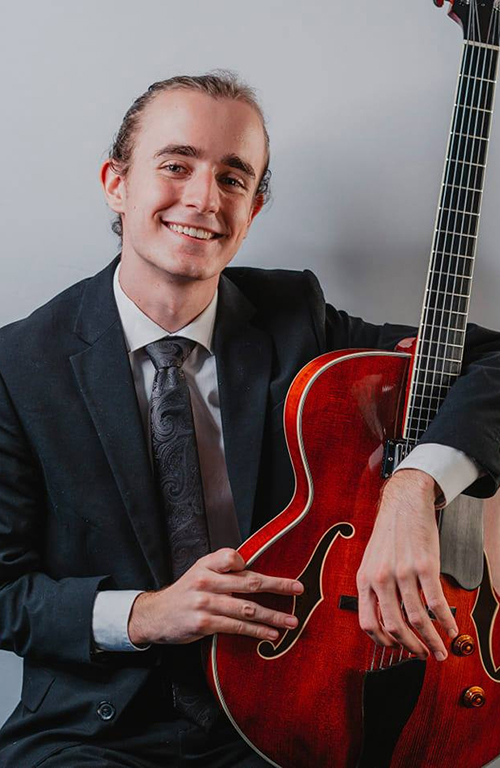 Alex Weibel poses with guitar.